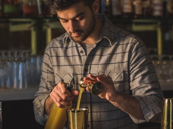 Emilio Salehi pouring a cocktail